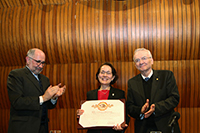 La doctora Estela Susana Lizano Soberón recibe el diploma y el pin con el que se formalizó su ingreso como miembro de El Colegio Nacional, en una ceremonia realizada en el Aula Mayor de la institución, la cual fue encabezada por los doctores José Ramón Cossío Díaz, presidente en turno; y Manuel Peimbert Sierra, responsable de la contestación a la lección inaugural.